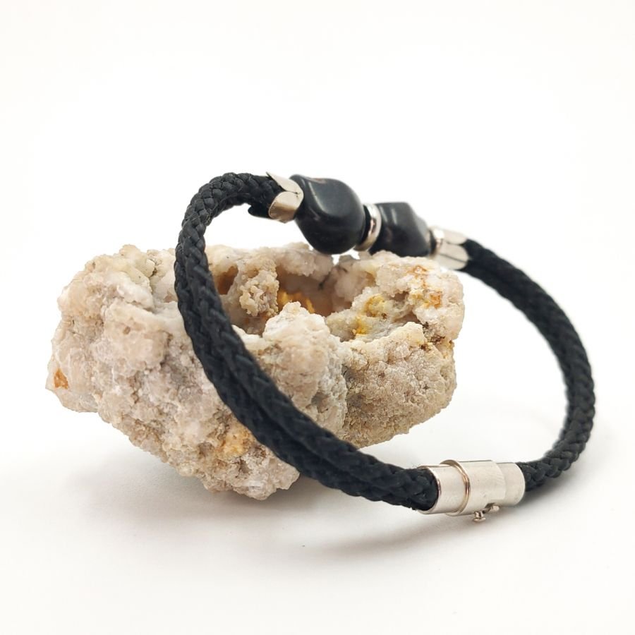 Dubbele schedel en gekruiste botten armband met zwarte stenen op dubbel touw
