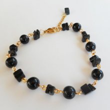 Onyx steen en vergulde stalen armband